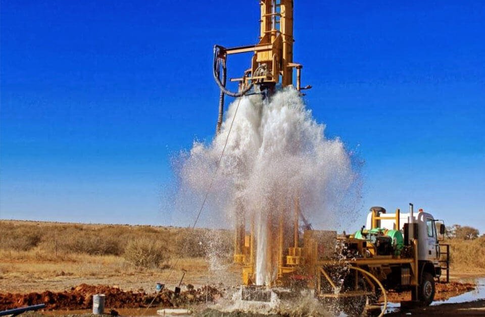 Lorry-mounted borewell drilling machine at a work site in Hyderabad